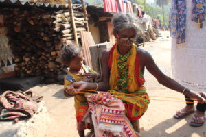 A tribal women knits a shawl